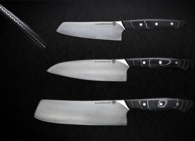 set of three knives against a black background