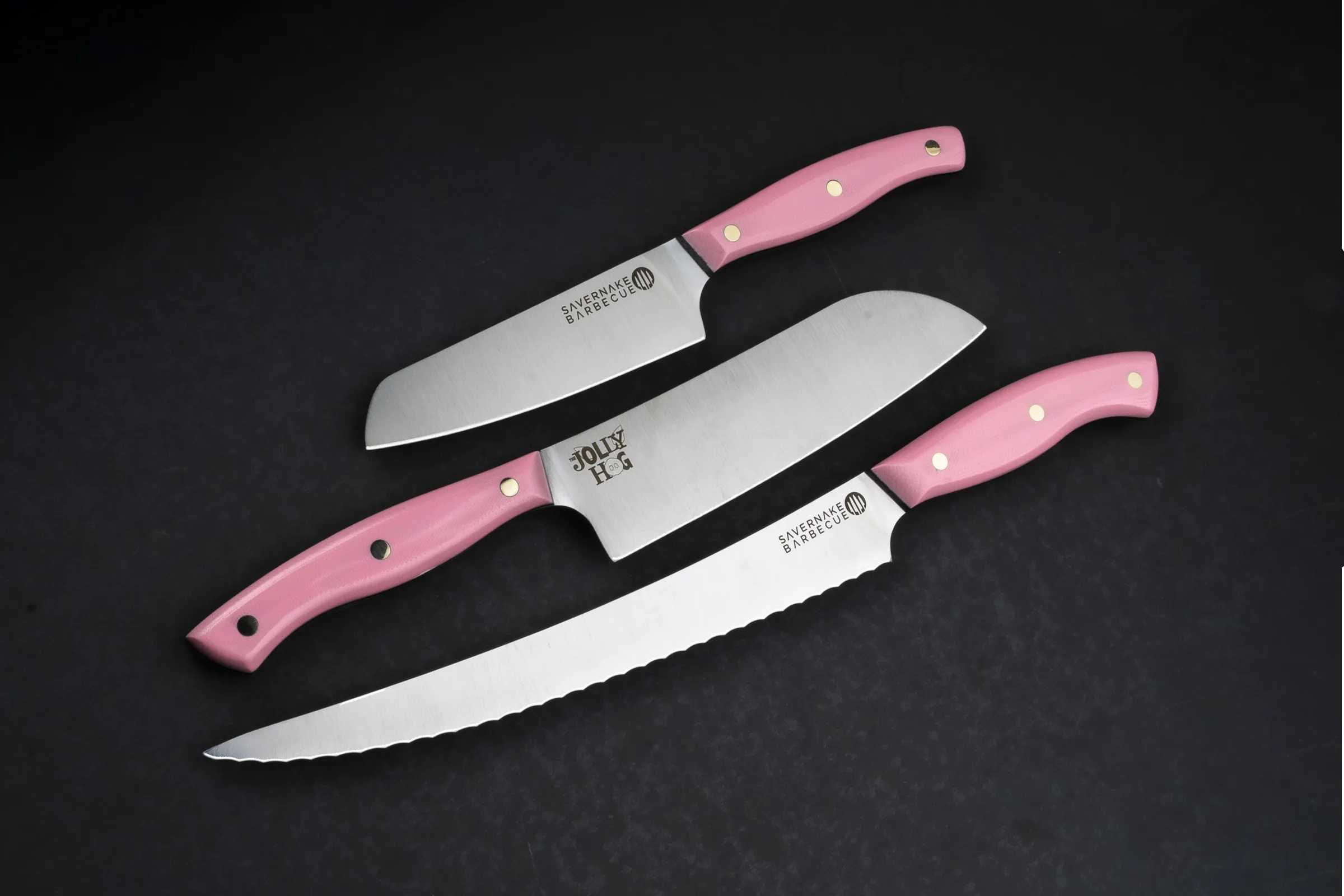 Three Savernake knives with baby pink G10 handles made for Jolly Hog
