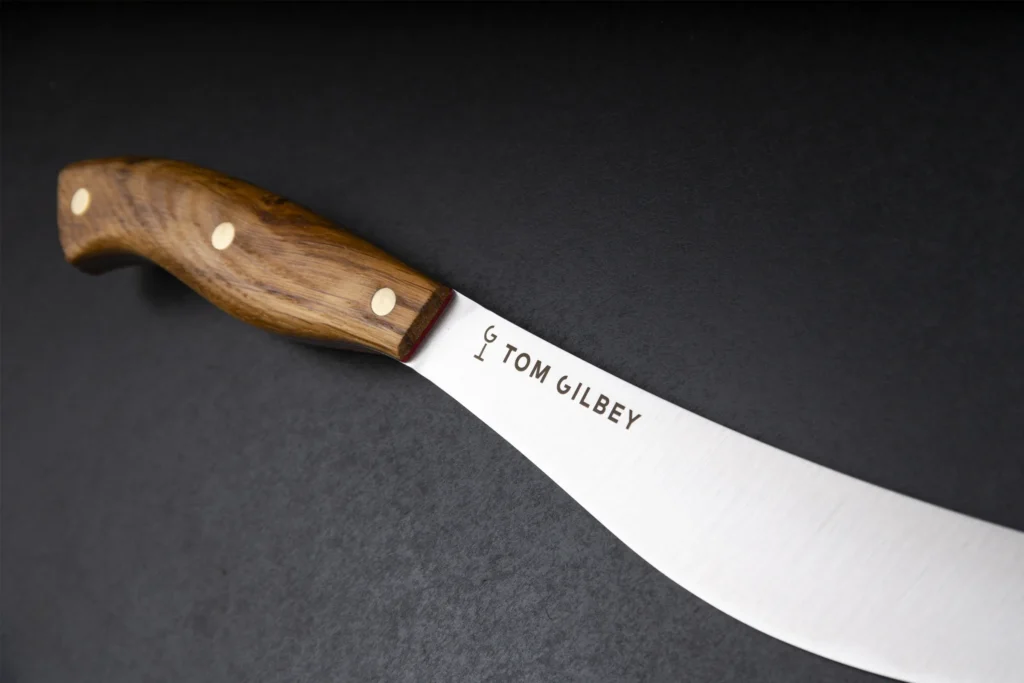 Oak-handled sabre with a red liner, edge left deliberately blunt