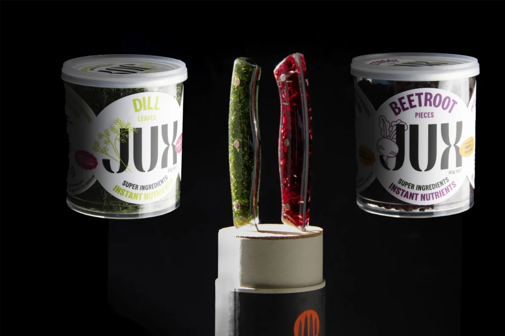 Santoku handle holding herbs and red onion suspended in optically clear resin