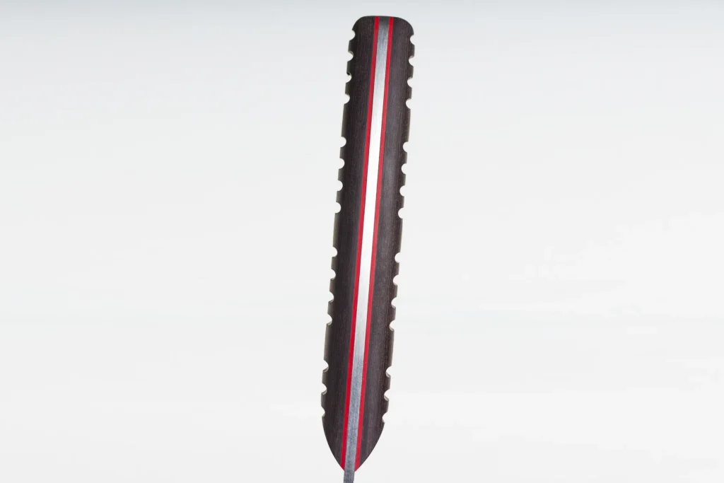 Layered Richlite handle showing bands of red, brown and black